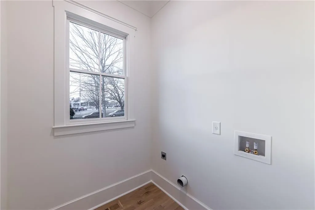 Laundry room featuring hookup for an electric dryer, wood finished floors, and washer hookup