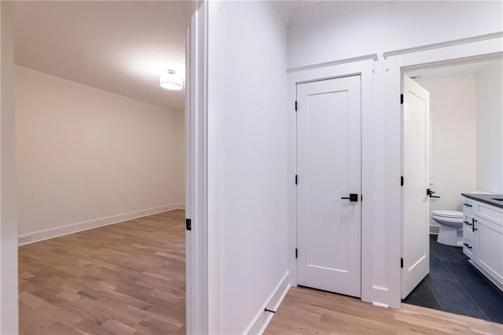 Hallway featuring light wood-style floors and baseboards