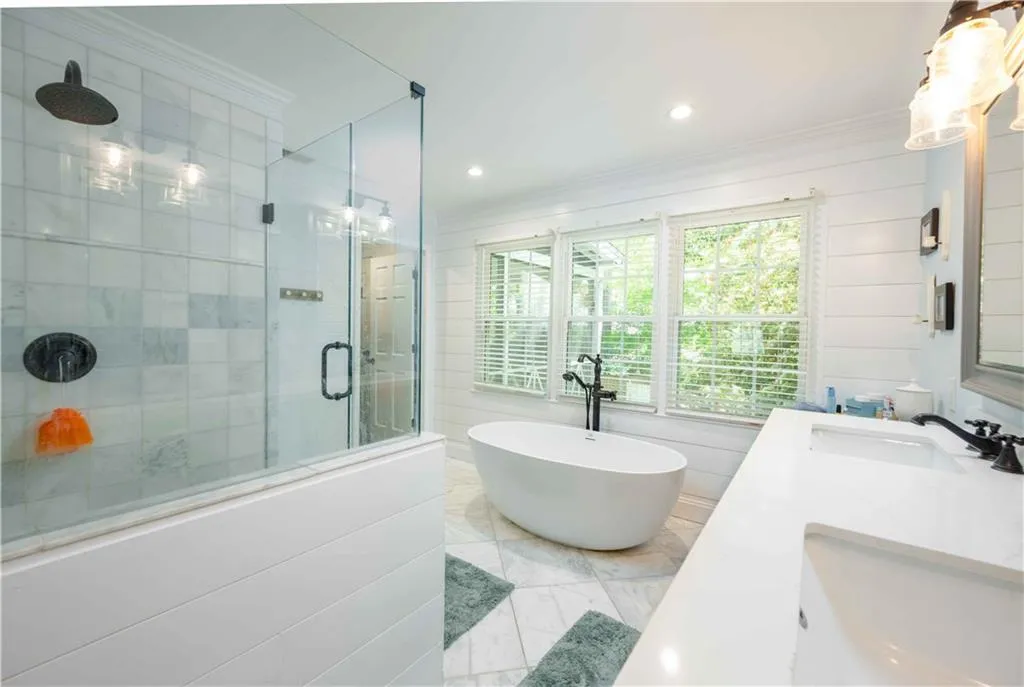 Bathroom with tile floors, double vanity, ornamental molding, and independent shower and bath