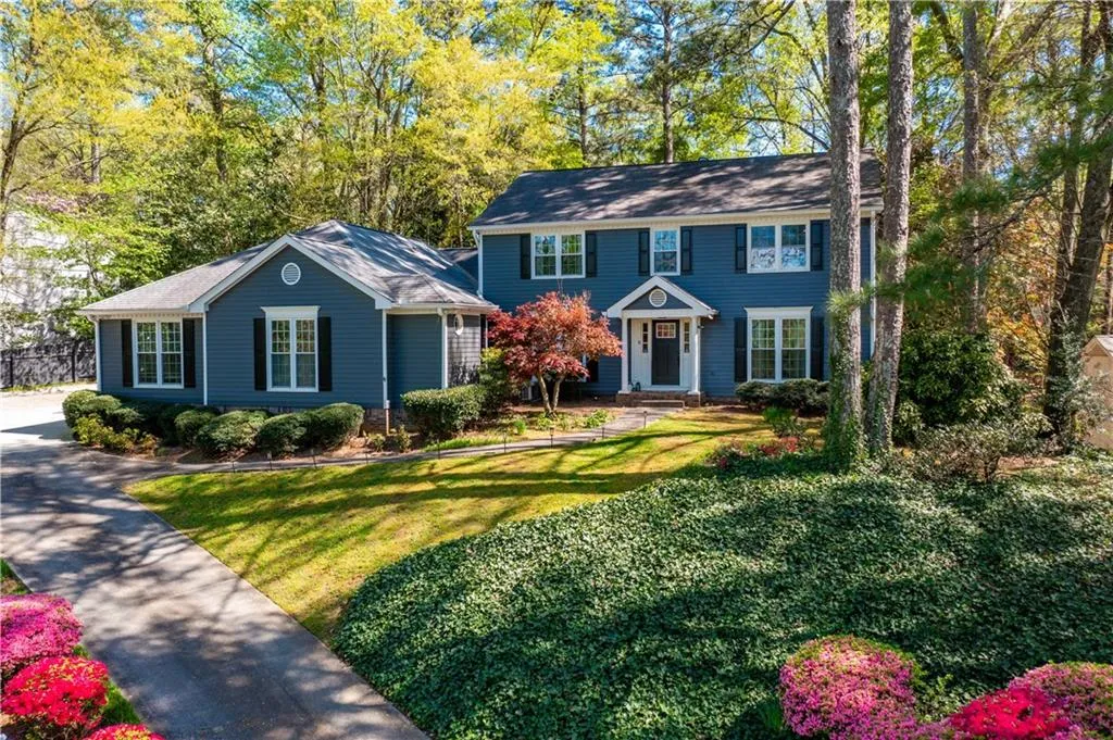 Colonial house featuring a front lawn