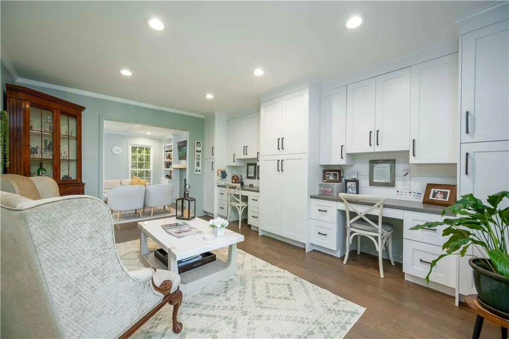 Sitting room with ornamental molding and dark hardwood / wood-style floors
