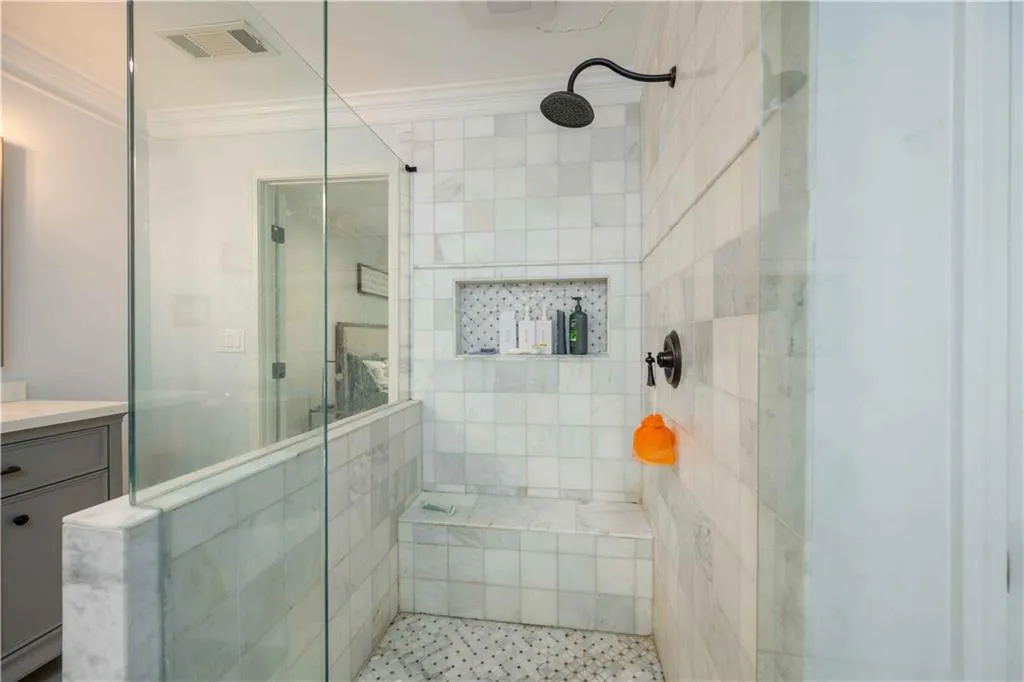 Bathroom featuring crown molding, an enclosed shower, and vanity