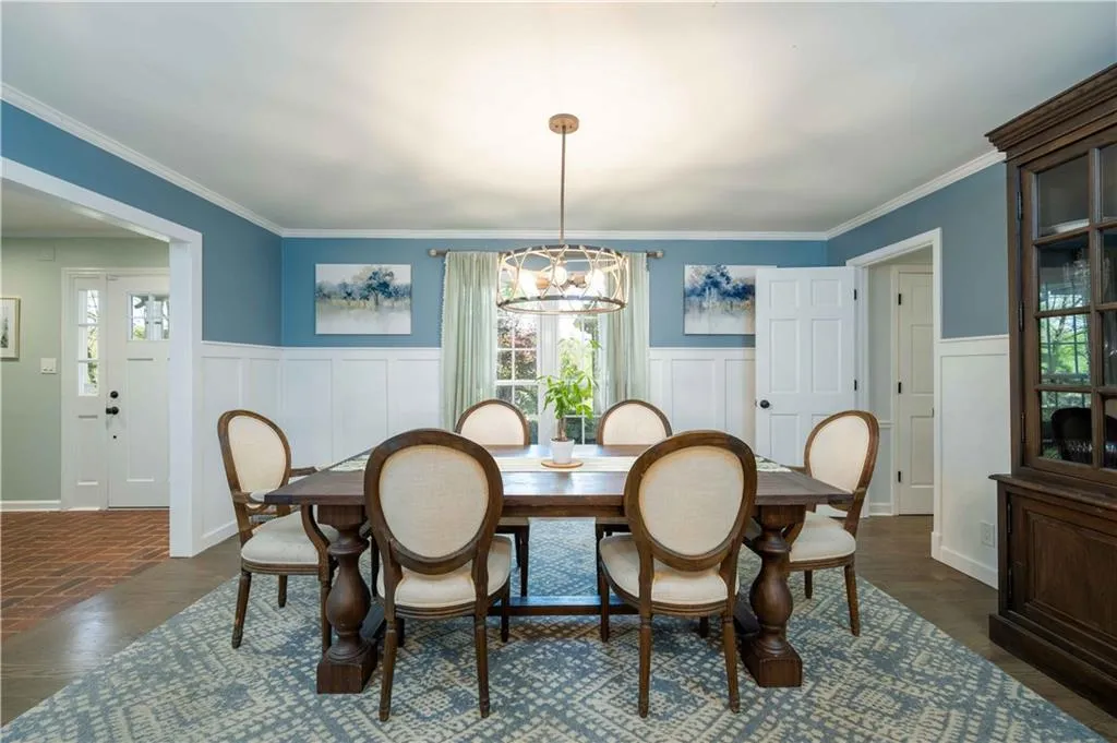 Dining area featuring a chandelier, dark hardwood / wood-style flooring, and ornamental molding