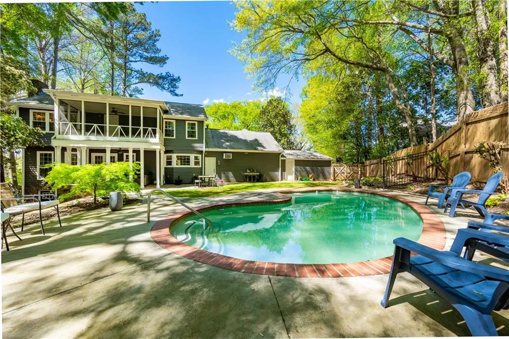 View of pool with a patio and a sunroom