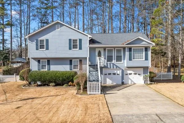 Light blue siding exterior with dark shutters and white trim
