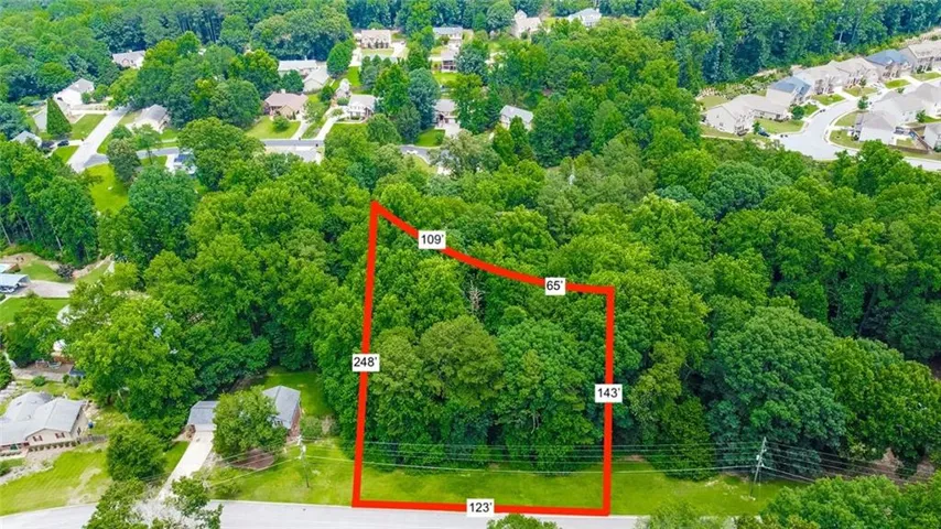 Expansive wooded lot featuring mature trees and a substantial 123-foot frontage. Outline is a visual not accurate.