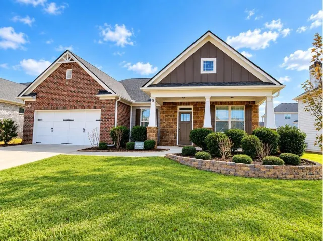 Brick and siding exterior with a covered porch featuring columns
