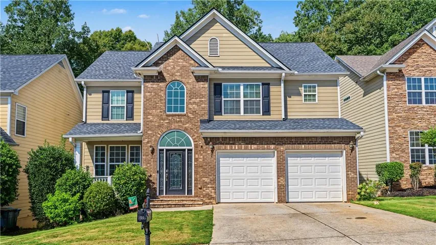 Brick and siding exterior with a two-car garage