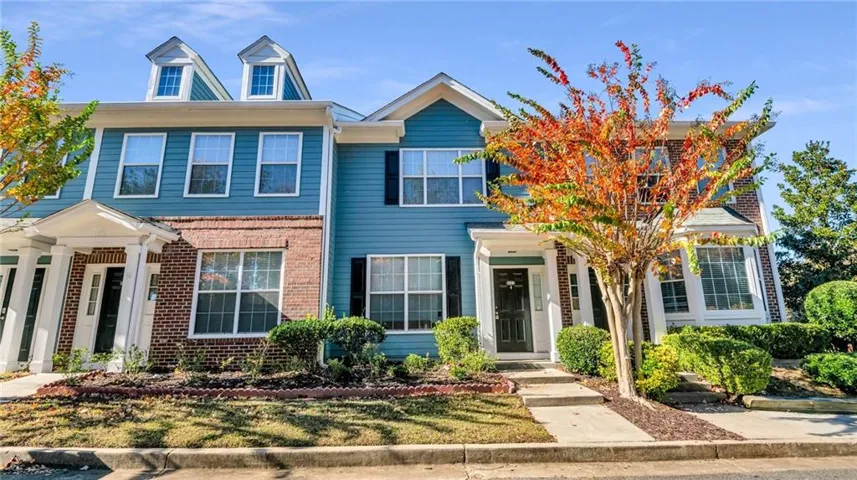Two-story townhome with siding and brick exterior
