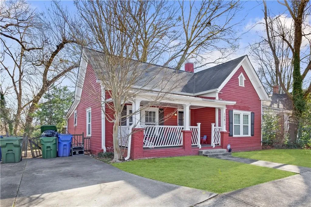 Bungalow-style house featuring covered porch and a front lawn