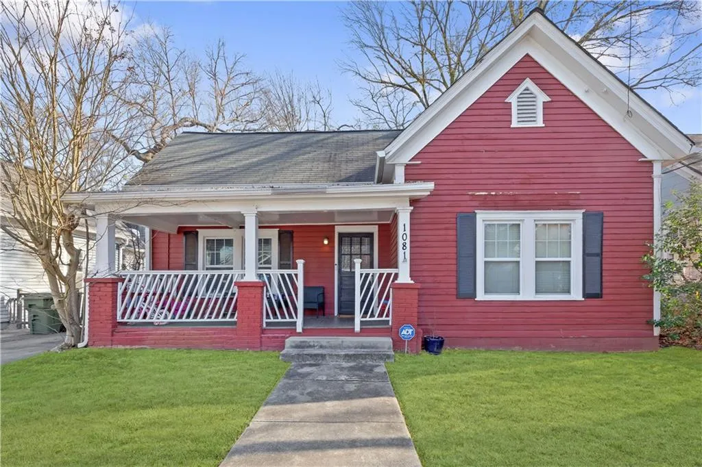 Bungalow-style house with covered porch and a front lawn