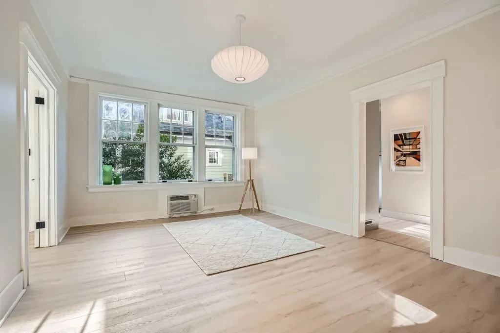 Open and bright with custom accented ceiling and original coved crown molding