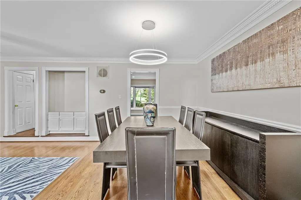 Dining room with crown molding and light wood-style flooring