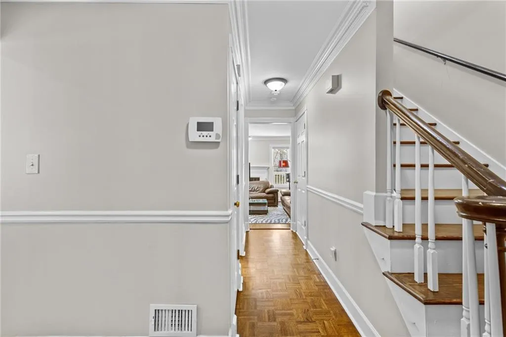 Corridor with ornamental molding and parquet flooring