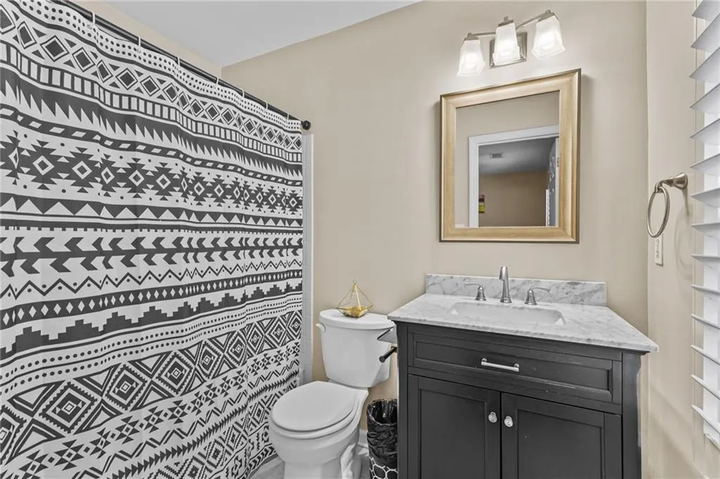 Bathroom with vanity and a shower with shower curtain