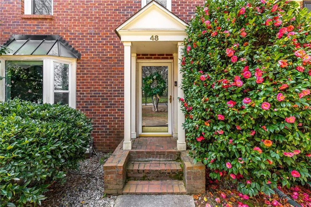 View of exterior entry with brick siding