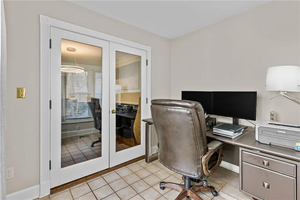 Office space with french doors and light tile patterned floors