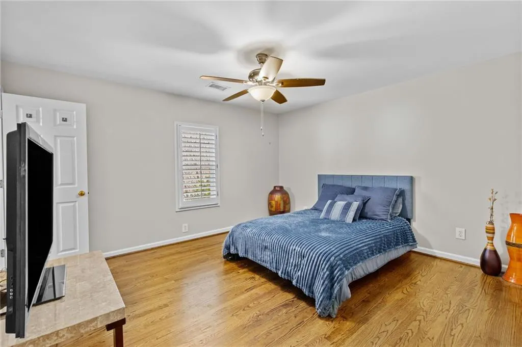 Bedroom with light wood-type flooring and a ceiling fan