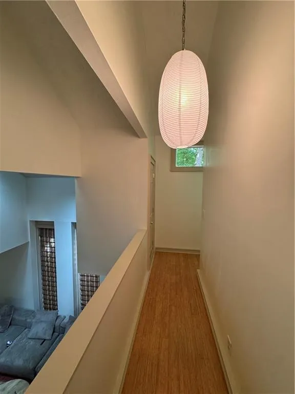 Hall with wood finished floors and baseboards