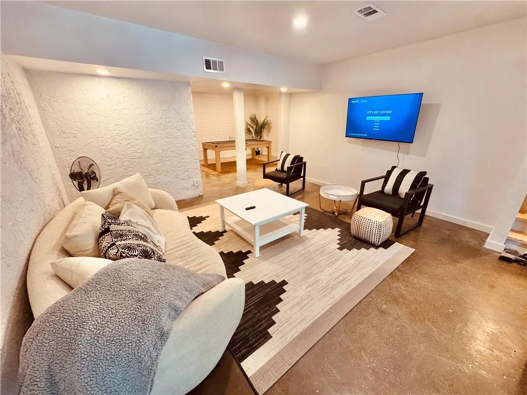 Living room featuring concrete flooring and recessed lighting