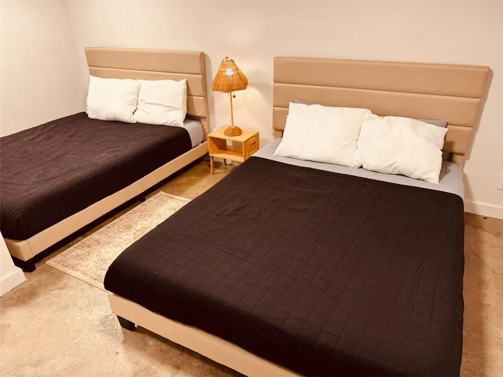 Bedroom featuring baseboards and carpet flooring