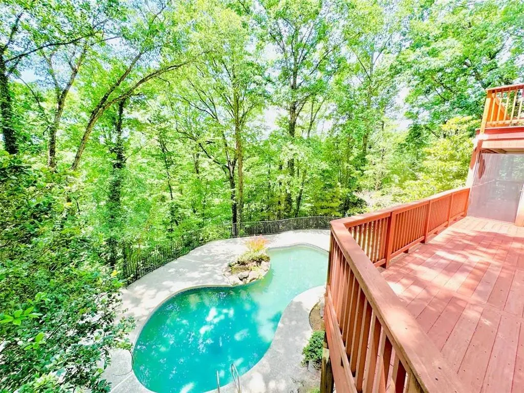View of swimming pool with a wooden deck