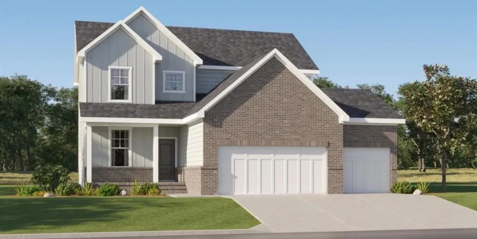 Two-story residence featuring a gray brick and light siding exterior