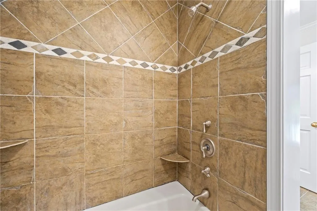 Bathroom featuring washtub / shower combination
