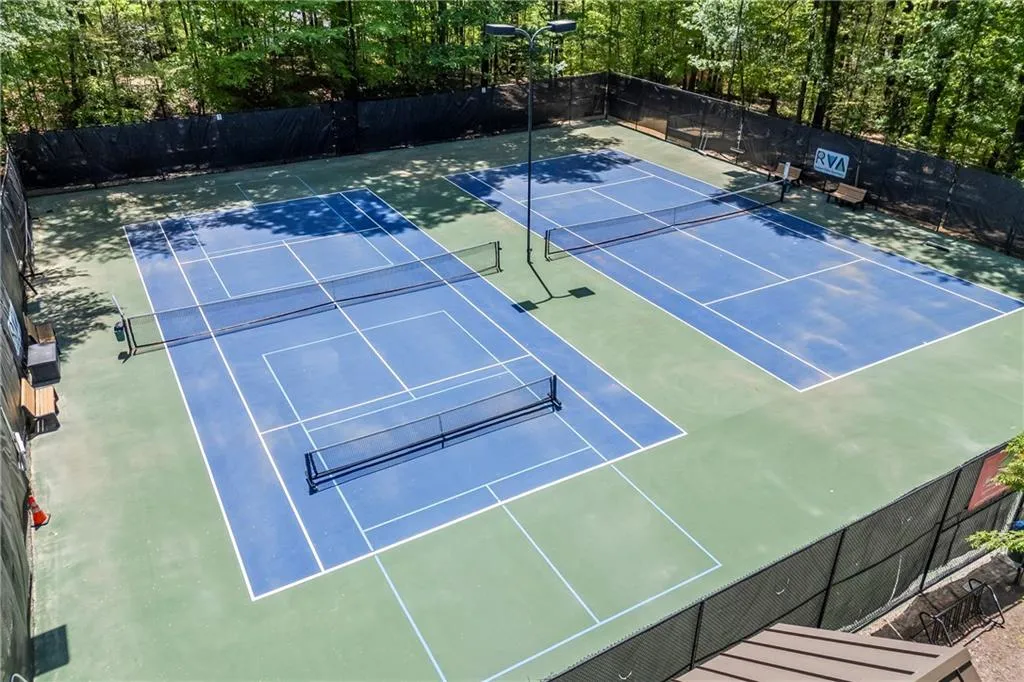 View of sport court with community basketball court, fence, and playground community