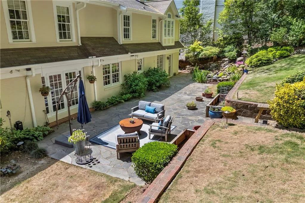 Rear view of property with outdoor lounge area, a patio, and a shingled roof