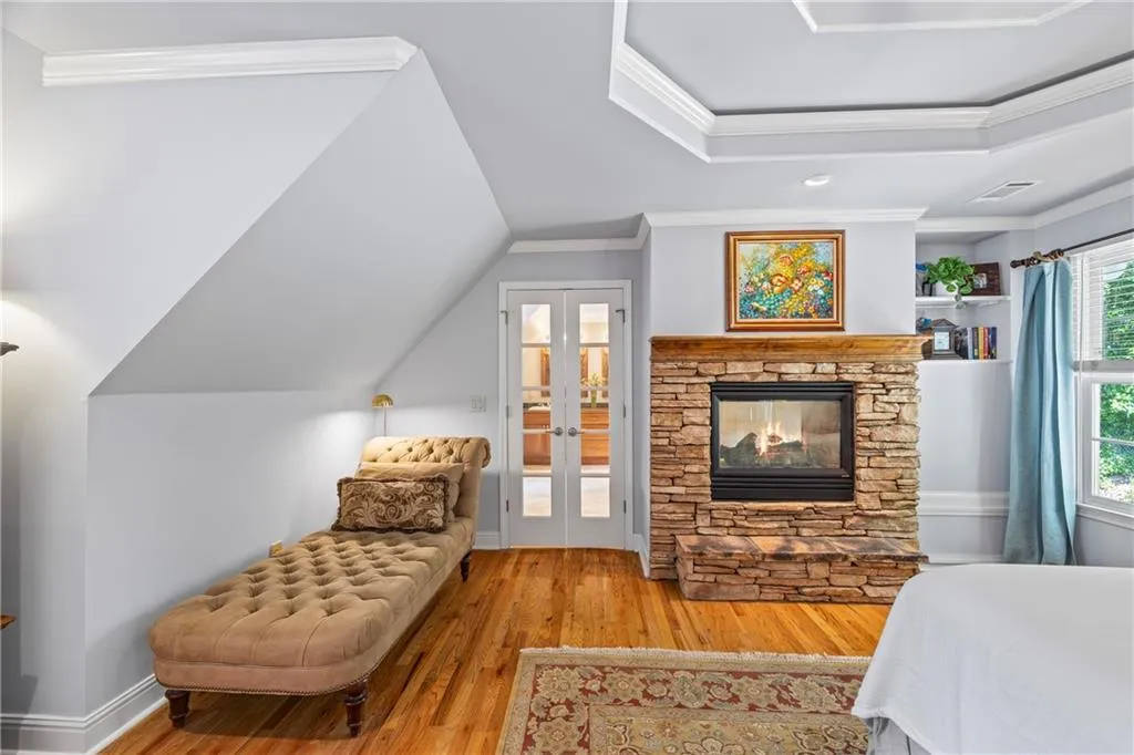 Bedroom with crown molding, french doors, wood finished floors, and visible vents