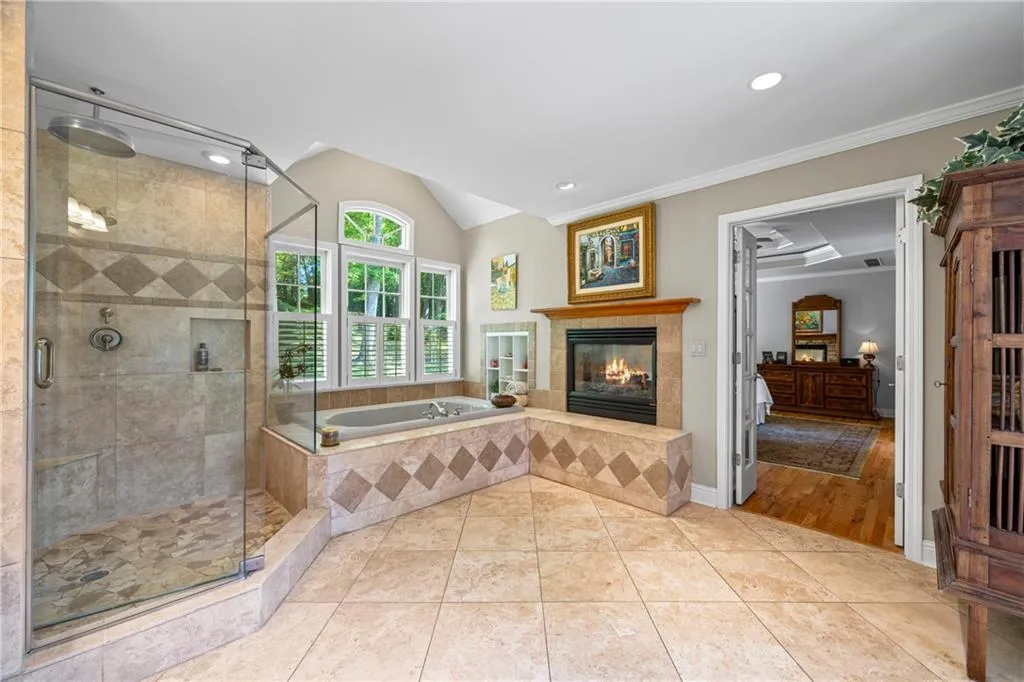 Living area featuring baseboards, crown molding, visible vents, and a tiled fireplace