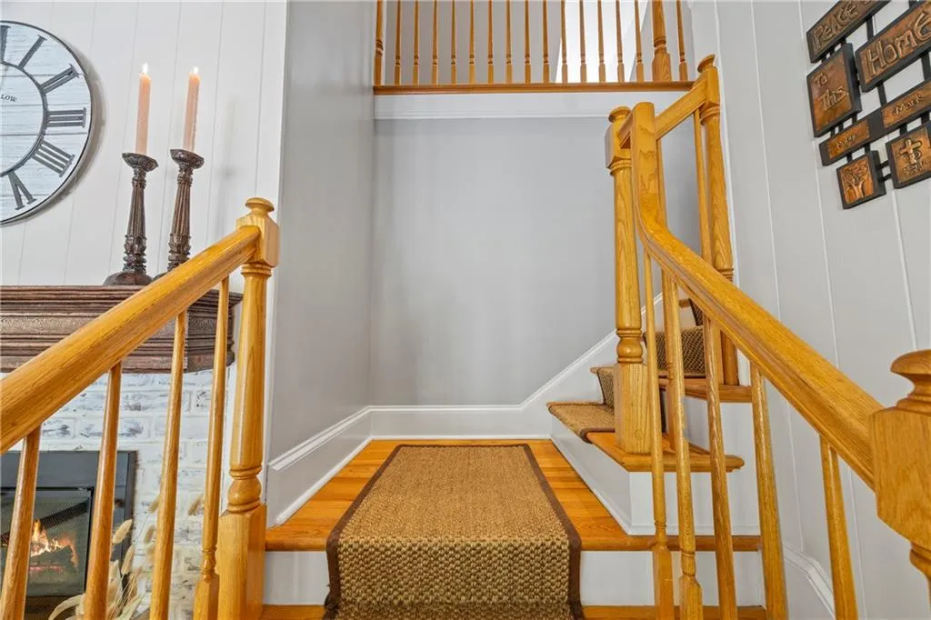 Staircase featuring wood finished floors and baseboards