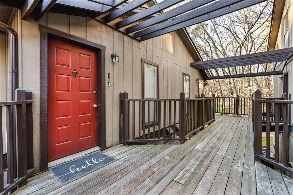 View of exterior entry with a wooden deck