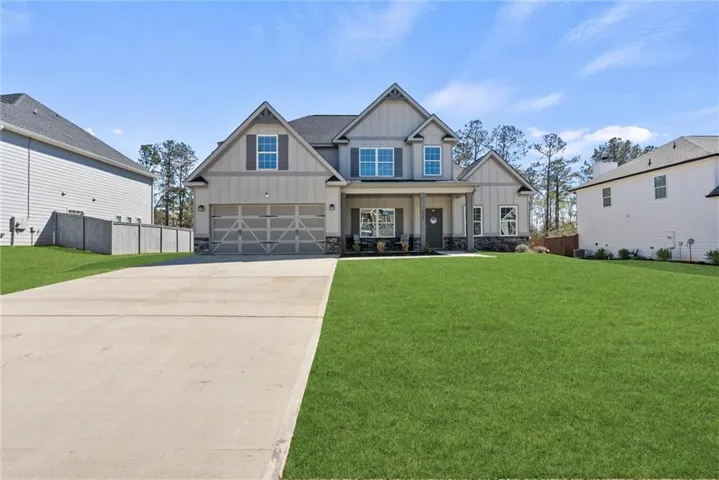 View of front of house featuring board and batten siding, a porch, concrete driveway, and an attached garage