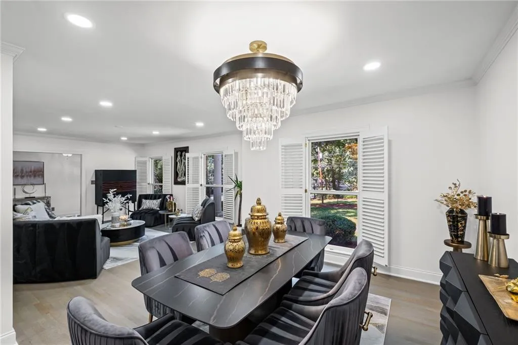 Dining area featuring crown molding, wood finished floors, a chandelier, and recessed lighting