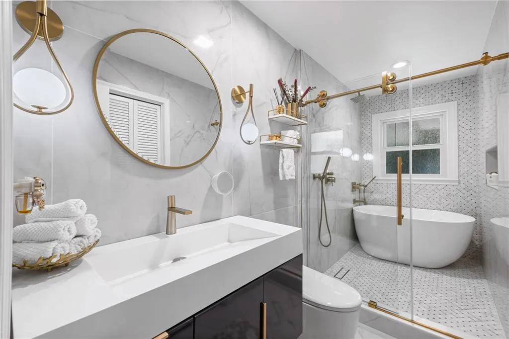 Full bathroom with tile walls, vanity, a stall shower, a freestanding bath, and recessed lighting