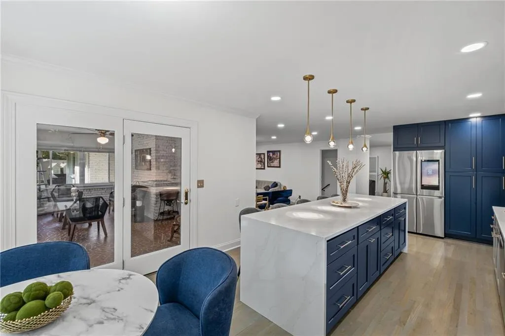 Kitchen featuring blue cabinetry, light wood-style floors, smart refrigerator, a center island, and recessed lighting