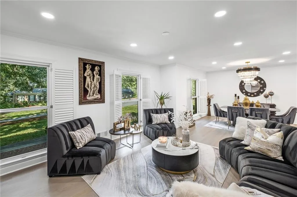 Living room featuring wood finished floors, recessed lighting, a chandelier, and ornamental molding
