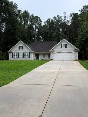 Light-colored siding exterior with a dark-pitched roof
