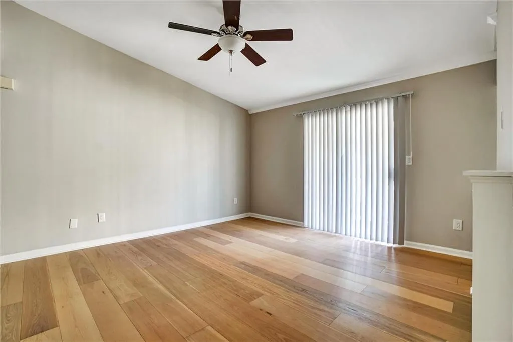 Empty room with light wood-style floors and a ceiling fan Empty room with light wood-style floors and a ceiling fan