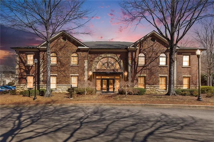Brick exterior with stone foundation and arched entryway