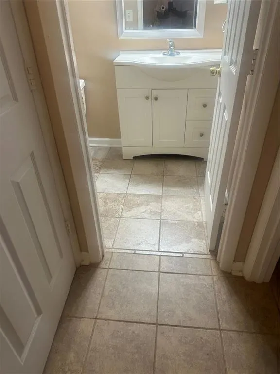Bathroom with vanity and light tile patterned flooring