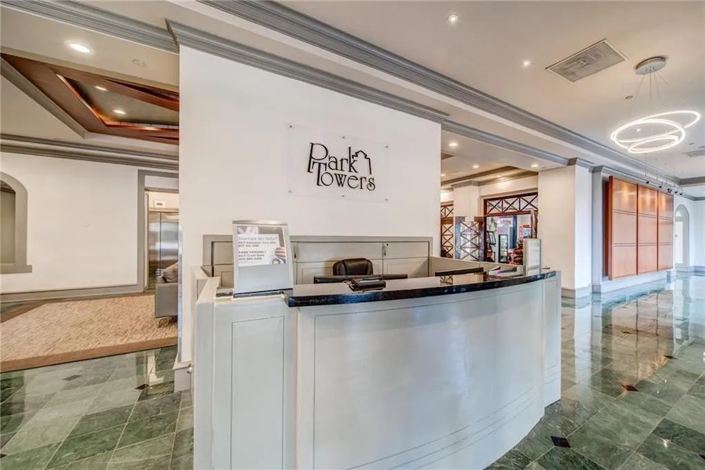 Reception with ornamental molding, recessed lighting, and arched walkways
