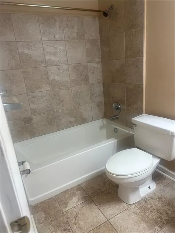 Bathroom with shower / bath combination and tile patterned flooring