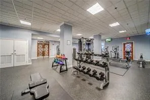 Workout area featuring baseboards and a paneled ceiling