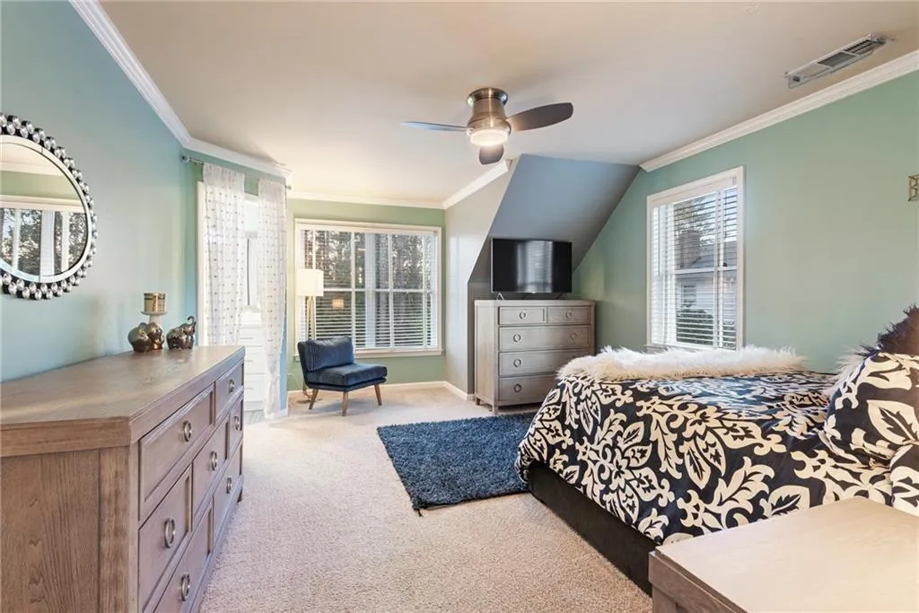 Spacious upstairs bedroom with lots of windows and new ceiling fan