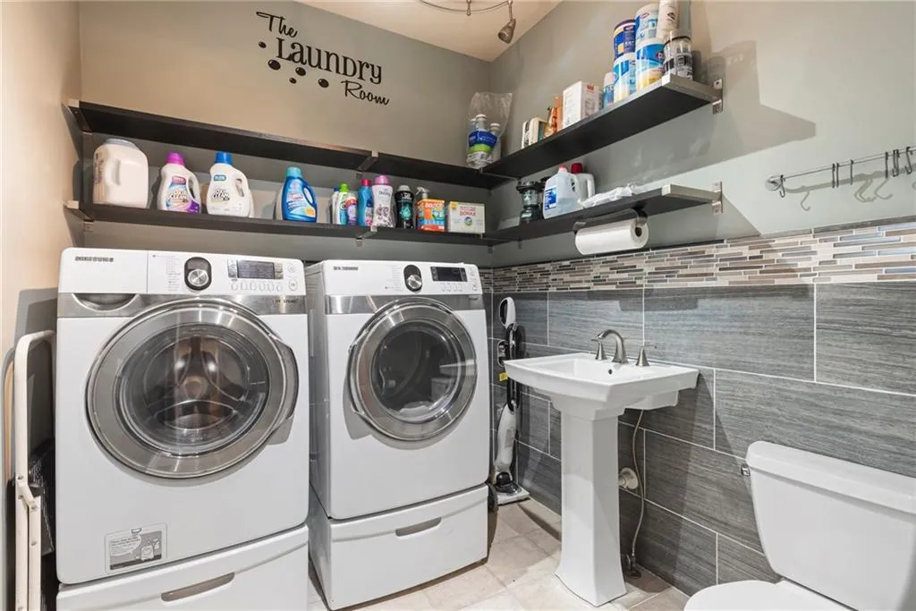 Main level laundry room off kitchen is generous and has toilet & sink incorporated for convenience.