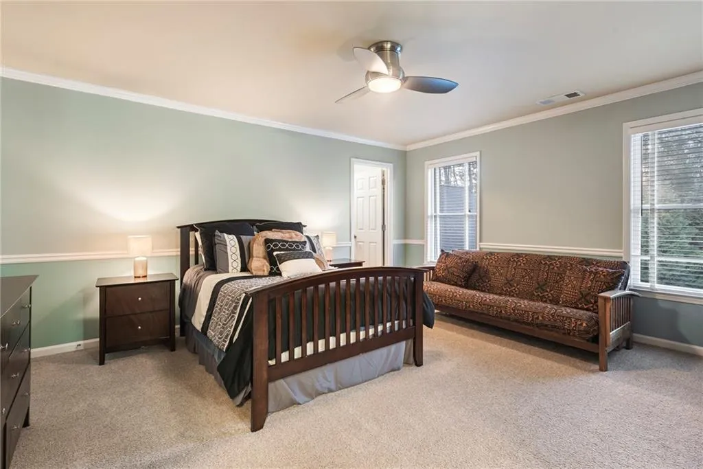 Spacious upstairs bedroom with lots of windows and walk-in closet