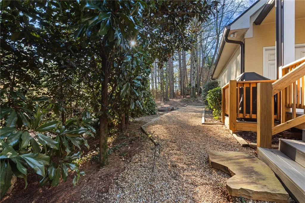 Very private rear yard just off new deck. Pebble walkway.
